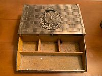 Closed jewelry box with interior drawer pulled out showing yellow lining and dividers