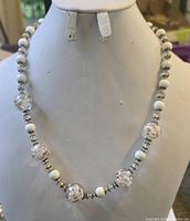 Full view of beaded glass necklace on display form