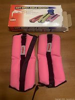 Pair of pink ankle weights and box