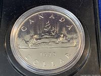 Obverse of 1975 Canada nickel dollar in capsule