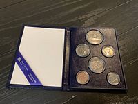 Open display folder showing all six encapsulated coins