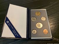 Closed open display case showing all six coins mounted