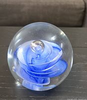 Front view of clear glass sphere showing blue rose swirl and central bubble