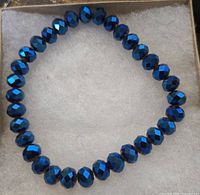 Full view of blue faceted glass/crystal bead stretch bracelet arranged in circle