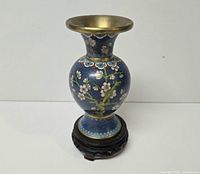Blue cloisonné floral vase on wooden stand