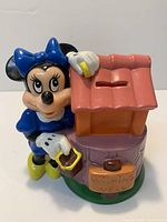 Front view of Minnie Mouse resin coin bank showing colors, coin slot and overall condition