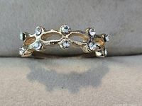 Front view of gold-tone rhinestone band ring