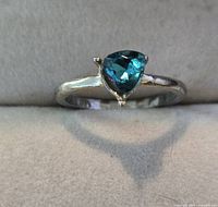 Top view of ring showing heart-shaped green stone and band