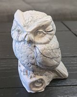 Front three-quarter view of howlite stone owl figurine showing carved details and glazing