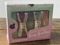 Front view of sealed Craft Your Own Lip Balm kit showing two glitter cases in window