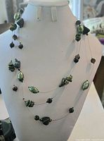 Front view of multi-strand glass bead necklace on display bust