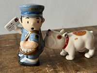 Postman and bulldog shakers standing together
