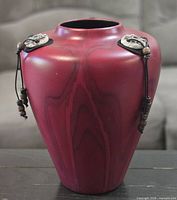 Front view of burgundy Sandstone Creations vase with decorative accents