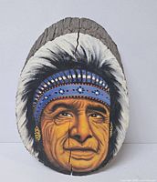 Front view of painted wood slice showing portrait and crack