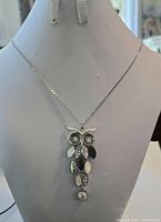 Full necklace on bust showing chain length and owl pendant