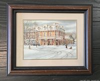 Framed winter scene print in wood frame