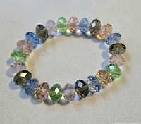 Full view of multicolor pastel faceted rondelle glass bead stretch bracelet arranged in circle