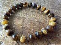 Full view of tiger's eye beaded stretch bracelet laid flat