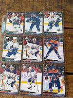 Front view of nine hockey trading cards in sleeve