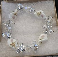 Overview of stretch bracelet showing lampwork glass, crystal clusters and metal spacers