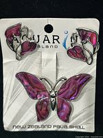 front view of brooch and earrings on Aquarius card