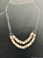 Front view showing double-strand rope and hammered metal beads