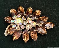 Front view of brooch showing stone arrangement and colors