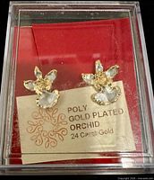Earrings in original case with brand card visible