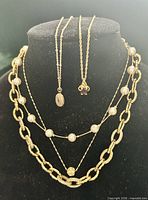 All five necklaces displayed on black bust mannequin