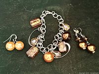 Bracelet and both earring pairs laid out