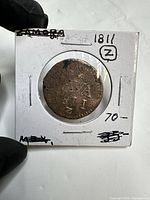 Front of coin in flip showing date 1811 and Z