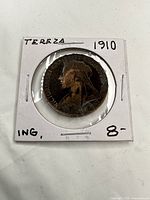 Front view of coin in holder showing obverse portrait