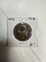 Obverse view of 1908 Edward VII penny in holder