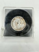 Coin obverse in plastic holder