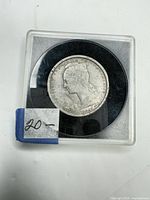 Obverse of 1948 2 francs coin in plastic holder showing female bust