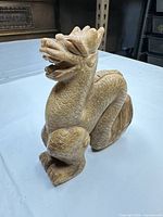 Front left view of carved stone dragon figurine