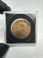 obverse showing worn portrait and corrosion