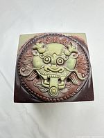 Top view showing detailed dragon–foo lion carving on seal