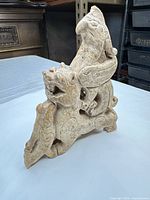 Front angled view of carved stone dragon sculpture