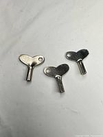 Three metal clock winding keys front view