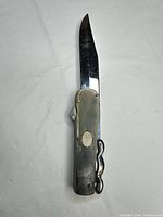 Knife closed, showing brass handle and lever