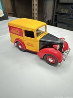 Left front view showing Coca-Cola graphics, colors, overall condition