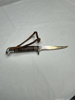 Full view of knife with strap