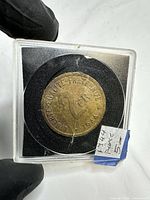 Obverse of 1944 2 Francs coin showing denomination and date inside holder