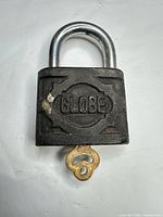 Front view showing GLOBE logo on padlock body with key inserted