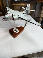 Front left view of Grumman S-2E Tracker model on wood stand