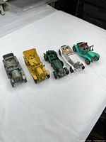 Five Lesney diecast vintage cars lined in a row