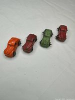 All four cast metal toy cars lined up