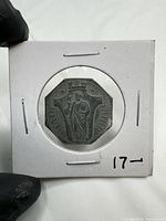 Token in 2×2 cardboard holder, obverse visible