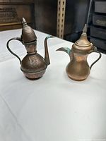 Both copper/brass Dallah coffee pots full view